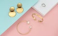 Top view of golden women accessories on pastel colors background