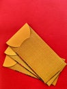 Top view of golden yellow color Chinese New Year envelopes with red background. Conceptual.