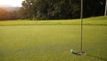 Top view of a golf ball on green course at hole Royalty Free Stock Photo