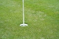 Top view of a golf course putting green with flag at hole Royalty Free Stock Photo