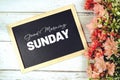 Good Morning Sunday text on blackboard with flower bouquet decoration Royalty Free Stock Photo