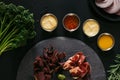 top view of gourmet craft meat with various sauces on black Royalty Free Stock Photo