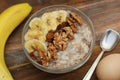 Top view of a Granola Bowl, Muesli with Oats, Nuts and Dried Fruit on Wooden table. Bannana, nuts, fruits. Healthy Breakfast. Diet Royalty Free Stock Photo