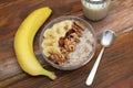 Top view of a Granola Bowl, Muesli with Oats, Nuts and Dried Fruit on Wooden table. Bannana, nuts, fruits. Healthy Breakfast. Diet