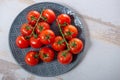 Top view of grape of cherry tomatoes on the blue plate Royalty Free Stock Photo