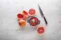 Top of view Grapefruit knife and juicer on white concrete background Royalty Free Stock Photo