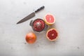 Top of view Grapefruit knife and juicer on white concrete background Royalty Free Stock Photo