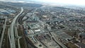 Top view of gray metropolis. Panorama of big city with areas and passing long highway in cloudy weather. Suburban Royalty Free Stock Photo