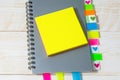 Top view of a gray notepad with colorful bookmarks and a blank yellow notepad. Business planning or training concept
