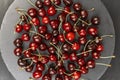 Top view gray plate with ripe sweet red cherry. Seasonal berries. Homemade organic cherries Royalty Free Stock Photo