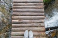 Top view gray sneakers on wooden bridge over river Royalty Free Stock Photo