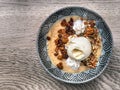 Top view of a greek halva - semolina with raisins, chopped nuts and ice cream on a plate.