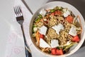 Top view of a greek salad bowl with cracked wheat, tomatoes, lettuce and feta chesse Royalty Free Stock Photo