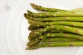 Top view of green asparagus on white plate