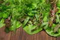 Top view of green dill, parsley, salad, herbs and other greens on a dark wooden background, concept of fresh vegetables and Royalty Free Stock Photo