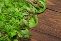 Top view of green dill, parsley, salad, herbs and other greens on a dark wooden background, concept of fresh vegetables and Royalty Free Stock Photo