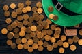 top view of green hat and golden coins on table, st patricks day concept Royalty Free Stock Photo