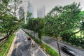 Top view green highway in Singapore with sidewalk and skyscrapers in background