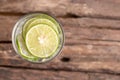 Top view green lime sliced in the soda water and glass place on the wooden table Royalty Free Stock Photo