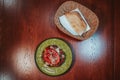 Top view of a green plate with a meat dish served with a loaf of bread Royalty Free Stock Photo