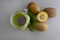 Top view of green smoothie with chia in mason jar on gray background with kiwis and spinach.Healthy diet concept with spinach, Royalty Free Stock Photo