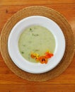 Top view of green soup with comestible flowers Royalty Free Stock Photo