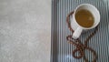 Top view of green tea in a cup with prayer beads or rosary placed in a tray Royalty Free Stock Photo