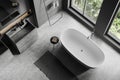 Top view of grey bathroom interior with sink and bathtub near panoramic window Royalty Free Stock Photo