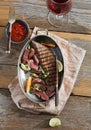 Top view grilled beef meat pan wooden table sauce red wine