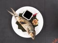 Top view of Grilled Boneless Bangus stuffed with vegetables and served with soysauce and Atchara. Bangus is also known as Milkfish