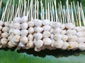 Top view of grilled pork balls skewers on fresh banana leaves Royalty Free Stock Photo