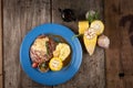 Top view of grilled rib eye steak with vegetables and potato puree in butter sauce Royalty Free Stock Photo