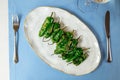 Top view on grilled spanish green padron peppers