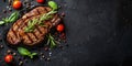 top view grilled steak with pepper herbs and tomatoes on stone black surface, flat lay with copy space, roast beef Royalty Free Stock Photo