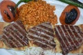 Grilled steak plate with roasted peppers, bulgur pilaf with tomatoes, roasted tomatoes