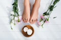 groomed female feet with flowers on Royalty Free Stock Photo