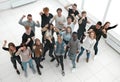 top view. a group of applauding young people looking at the camera. Royalty Free Stock Photo