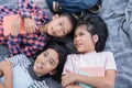 Top view. Group of Asian elementary school children talk while lying on the blanket and relaxation in the summer at park in Royalty Free Stock Photo