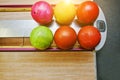 Top view of group colored bowling balls at bowl lift