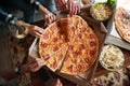 Top view of a group of friends eating big pizza Royalty Free Stock Photo