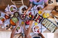 Top view of group of friends haveing fun together ina healthy vegetarian fresh seasonal brunch together - coloured and energetic