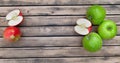 Apples on a plank and others green with copy space between