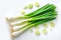 Top view of group of green scallions and circle slices with shadows