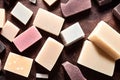 Top view of a group of handmade sliced of soap on the brown background