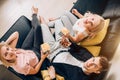 Cheerful group of friends eating popcorn at home Royalty Free Stock Photo