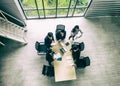 Top view of group of multiethnic busy people working in an office, Aerial view with businessman and businesswoman sitting around a Royalty Free Stock Photo