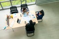 Top view of group of multiethnic busy people working in an office, Aerial view with businessman and businesswoman sitting around a Royalty Free Stock Photo