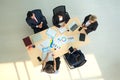 Top view of group of multiethnic busy people working in an office, Aerial view with businessman and businesswoman sitting around a Royalty Free Stock Photo