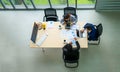 Top view of group of multiethnic busy people working in an office, Aerial view with businessman and businesswoman sitting around a Royalty Free Stock Photo