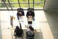 Top view of group of multiethnic busy people working in an office, Aerial view with businessman and businesswoman sitting around a Royalty Free Stock Photo